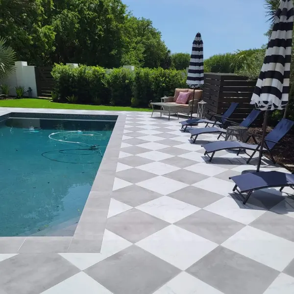 Newly installed paver patio around a backyard pool