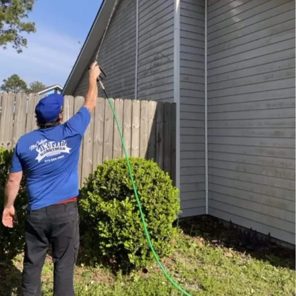 McCallum Handyman Services technician pressure washing a home exterior